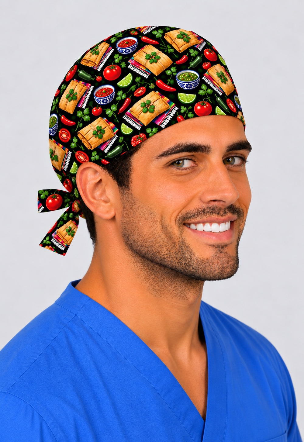 Smiling Latino surgeon in a Mexican tamale tie-back scrub cap with salsa, chiles and serape print