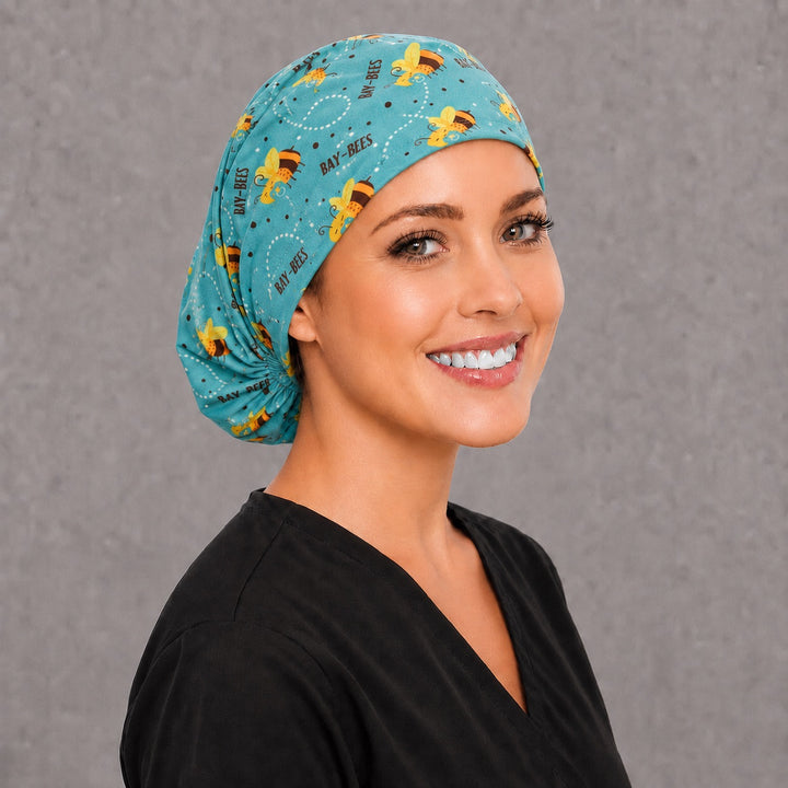 Teal bumblebee Euro surgical cap, left angled view — elastic adjustable back with full head coverage