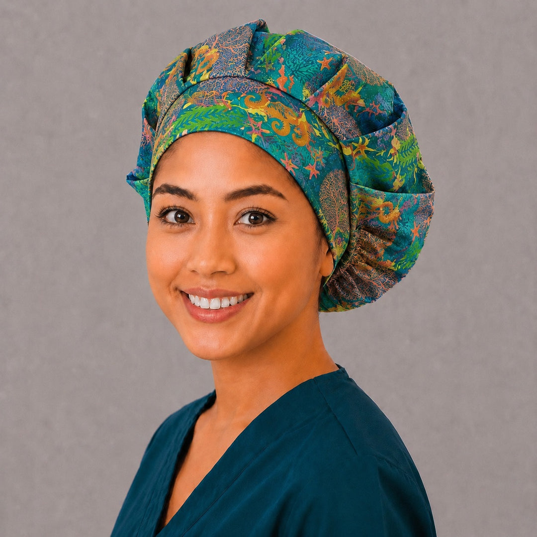 Teal marine life bouffant cap for women, angled smiling view — handmade tropical reef surgical cap, USA made