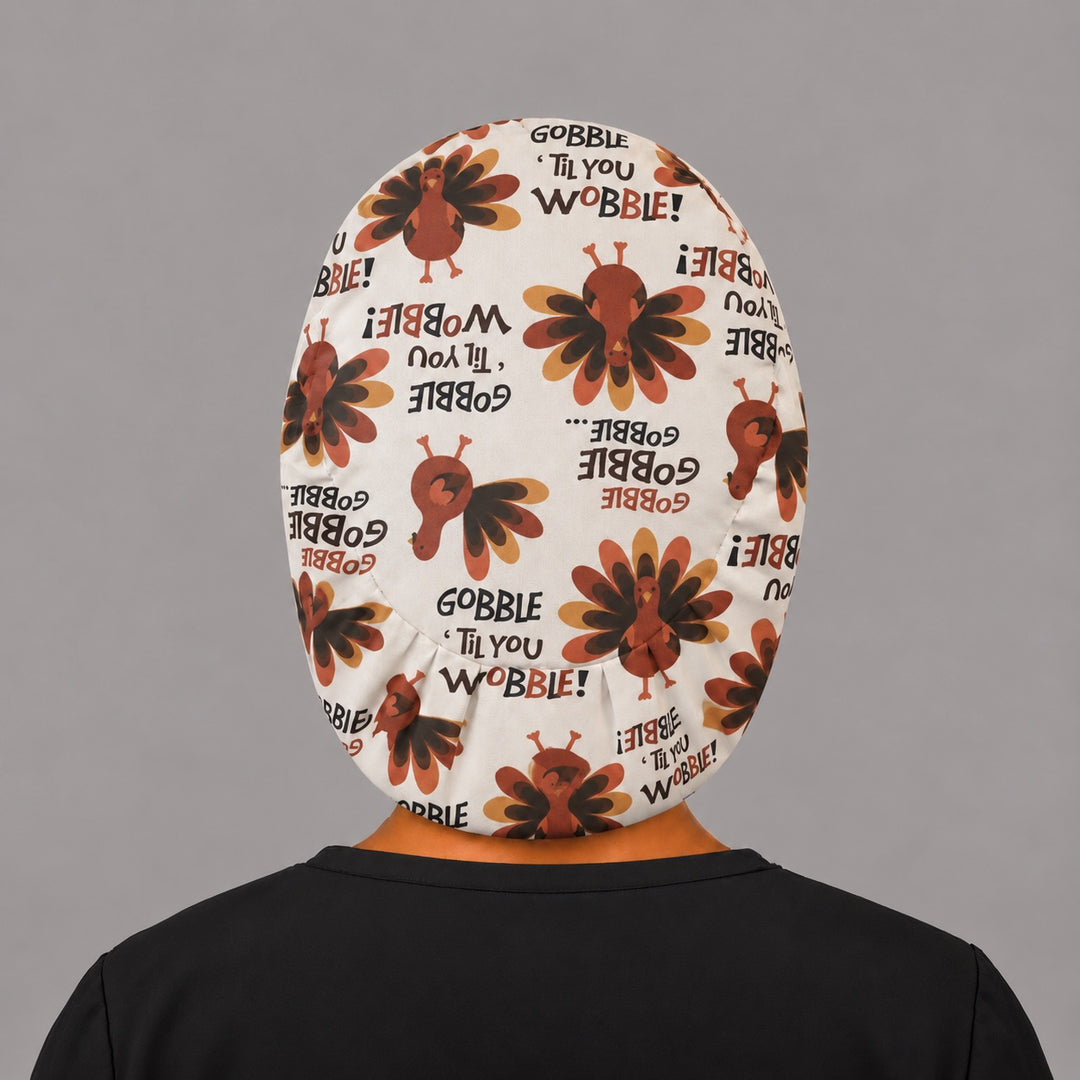 Back view of the Thanksgiving turkey Euro scrub cap — elastic gathered back showing turkeys and Gobble lettering across the cream crown