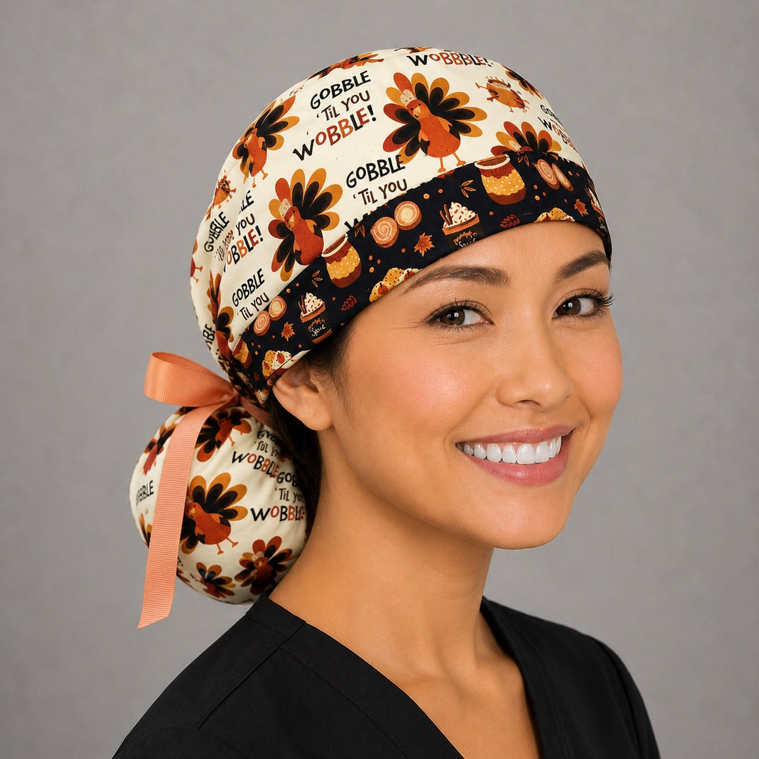 Thanksgiving turkey ponytail nurse cap right three-quarter angle on smiling model showing turkeys and Gobble Til You Wobble text with pumpkin-spice band and peach ribbon bow