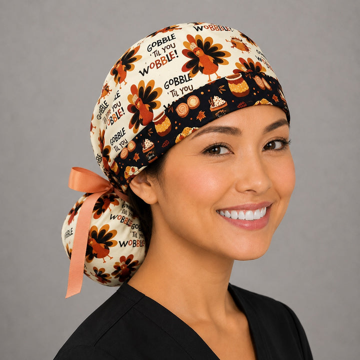 Thanksgiving turkey ponytail nurse cap right three-quarter angle on smiling model showing turkeys and Gobble Til You Wobble text with pumpkin-spice band and peach ribbon bow