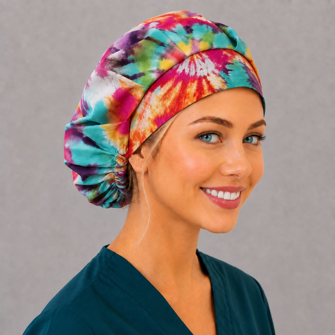 Back view of the tie-dye bouffant scrub cap — full gathered fit showing rainbow sunburst spirals across the crown