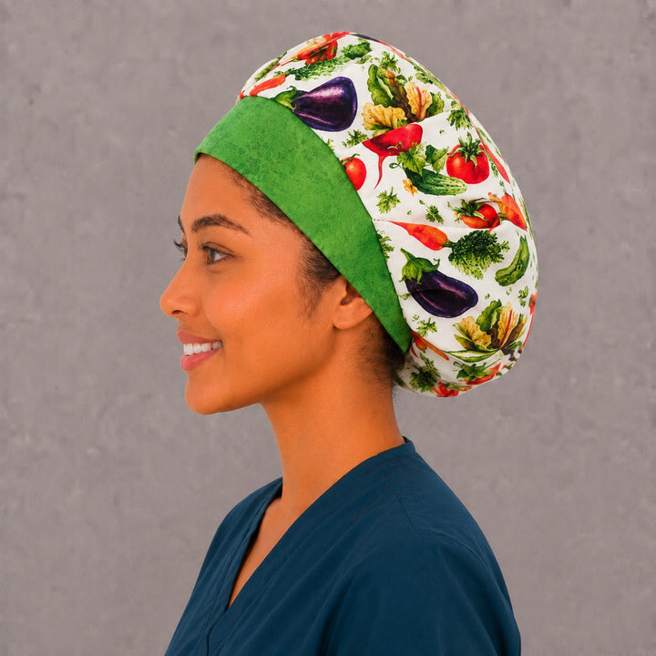 Tomato and eggplant bouffant surgical cap for long hair, left side profile — deep gathered fit that secures thick or braided hair