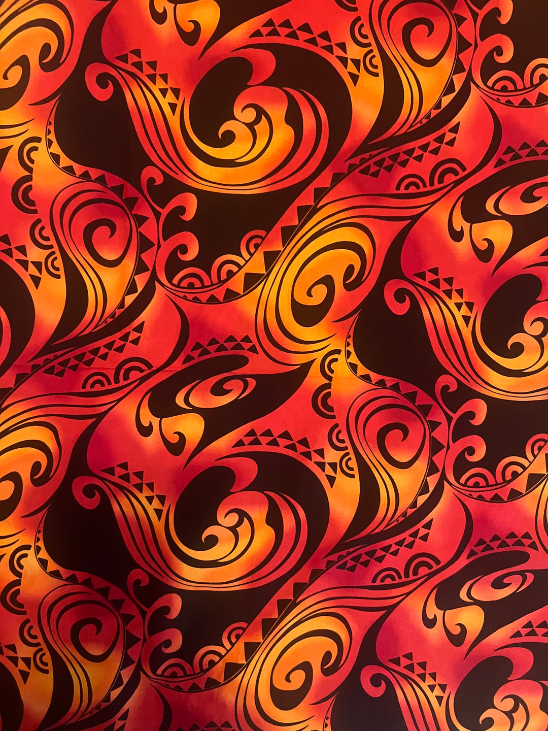 Fabric detail of the Tribal Flame scrub cap — close-up of red, orange and black Polynesian flame print