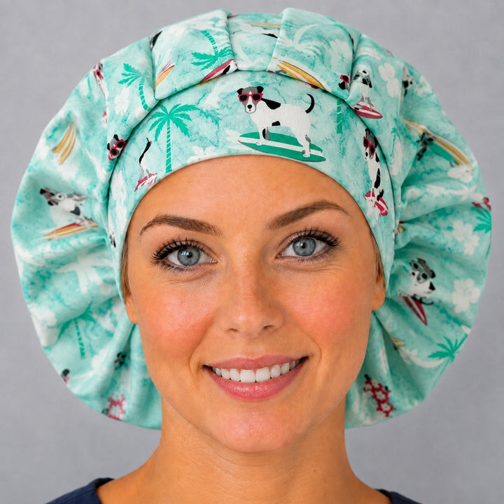 Tropical beach dog bouffant cap for women, angled smiling view — handmade mint surf dog print surgical cap, USA made