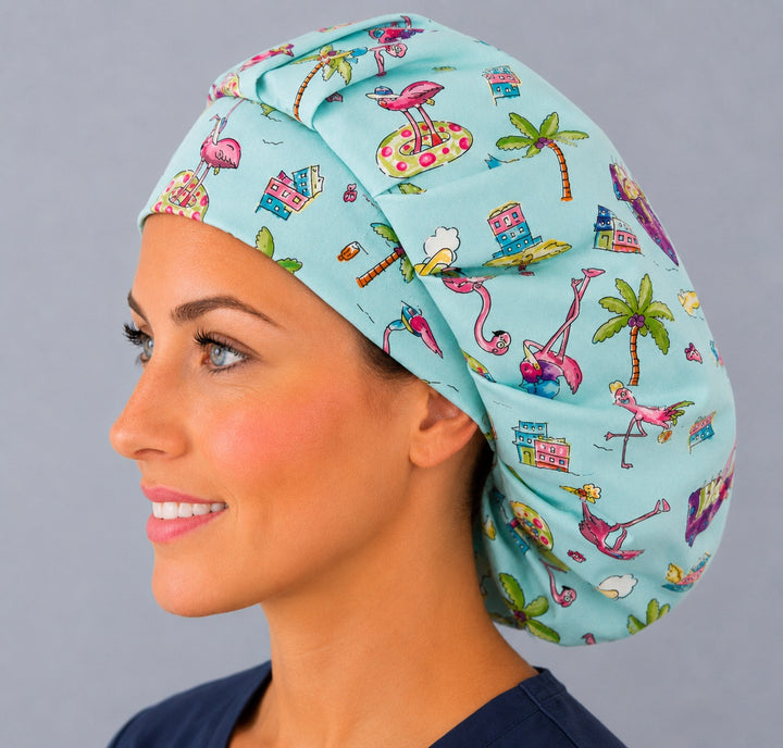 Profile view of the tropical flamingo beach bouffant surgical hat — pink flamingos and palm trees, a cheerful summer gift for nurses and techs