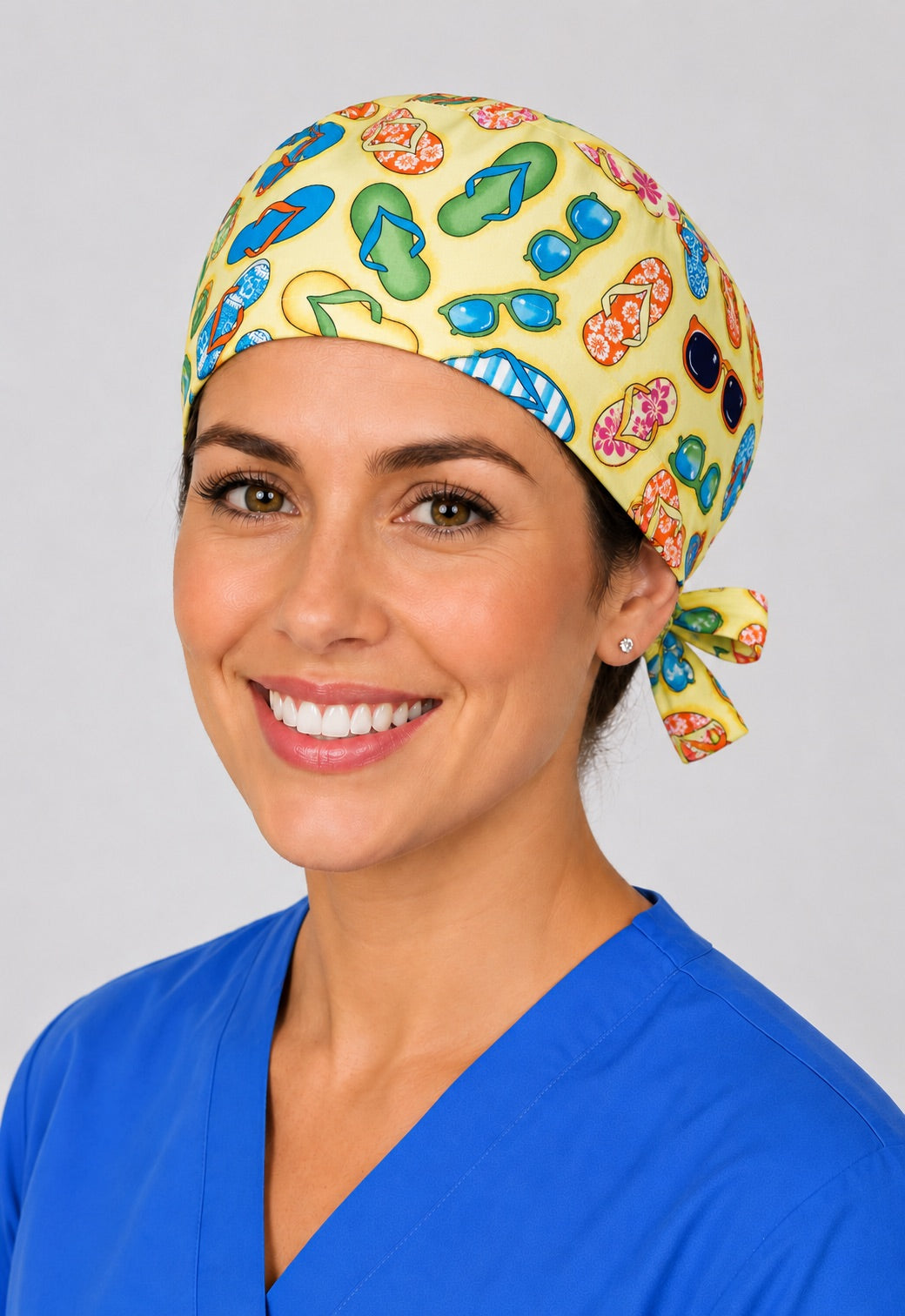Nurse wearing tropical flip flop tie back scrub cap, yellow summer sandal print surgical hat with side tie by OR World