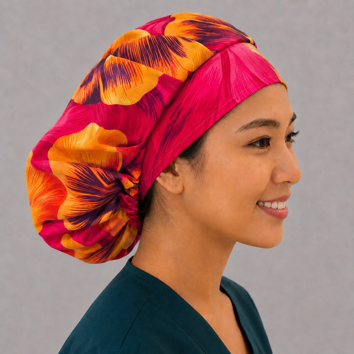 Tropical Hawaiian hibiscus bouffant scrub cap back view showing full print of oversized hot pink, orange and yellow hibiscus flowers, OR World tropical surgical hat