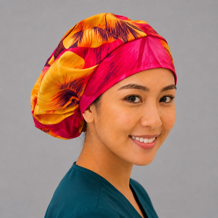Tropical Hawaiian hibiscus bouffant scrub cap for women, front view, oversized hot pink and orange hibiscus flowers, handmade surgical hat by OR World