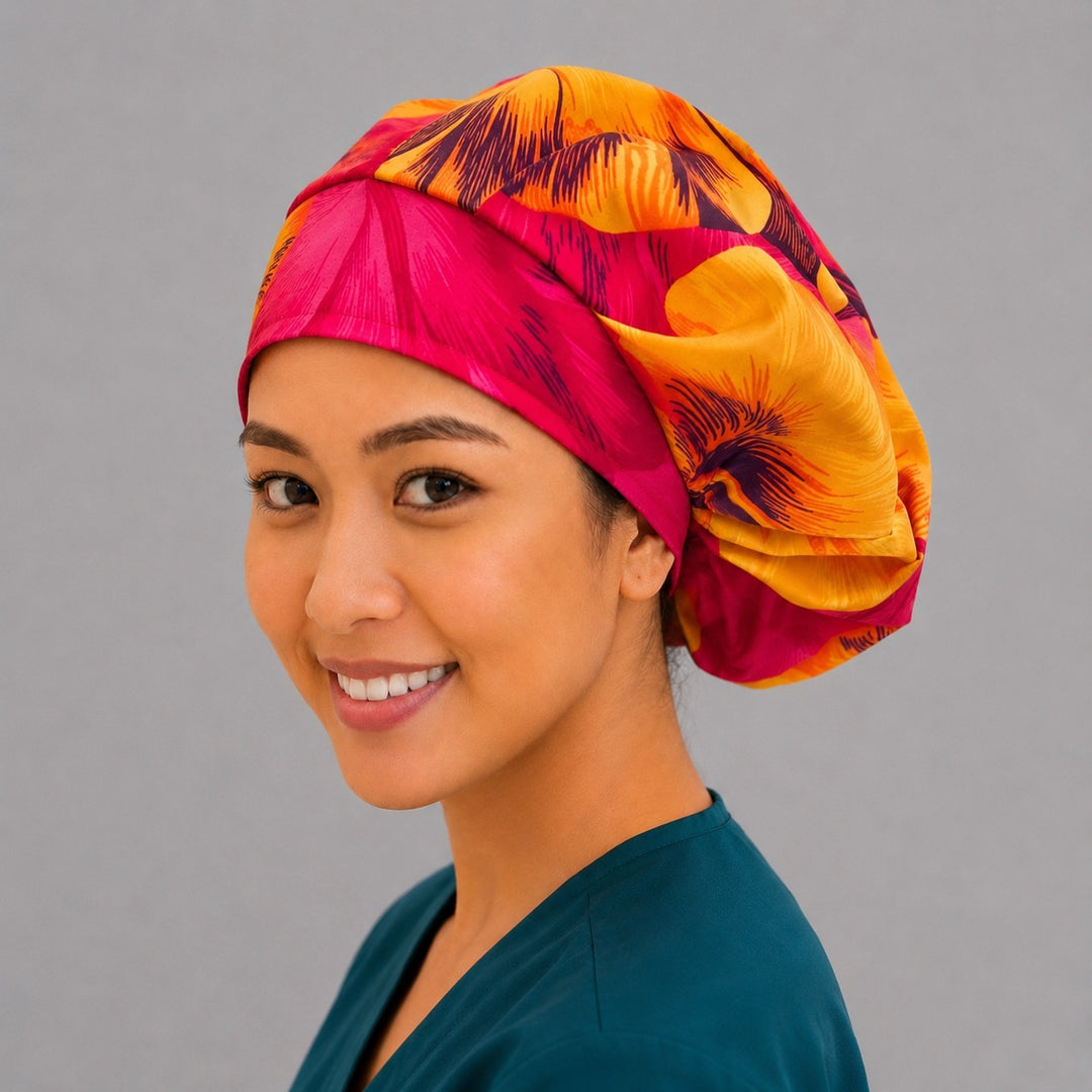 Tropical Hawaiian hibiscus bouffant scrub cap right three-quarter angle on smiling model showing hot pink and orange hibiscus flowers, OR World tropical nurse hat
