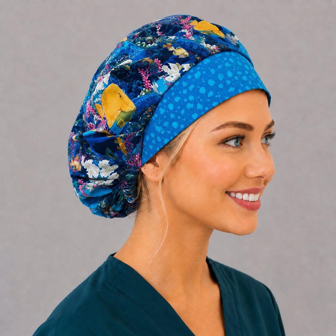 Right side profile of the tropical reef fish bouffant surgical hat — yellow tang and coral print, roomy breathable cotton cap for nurses
