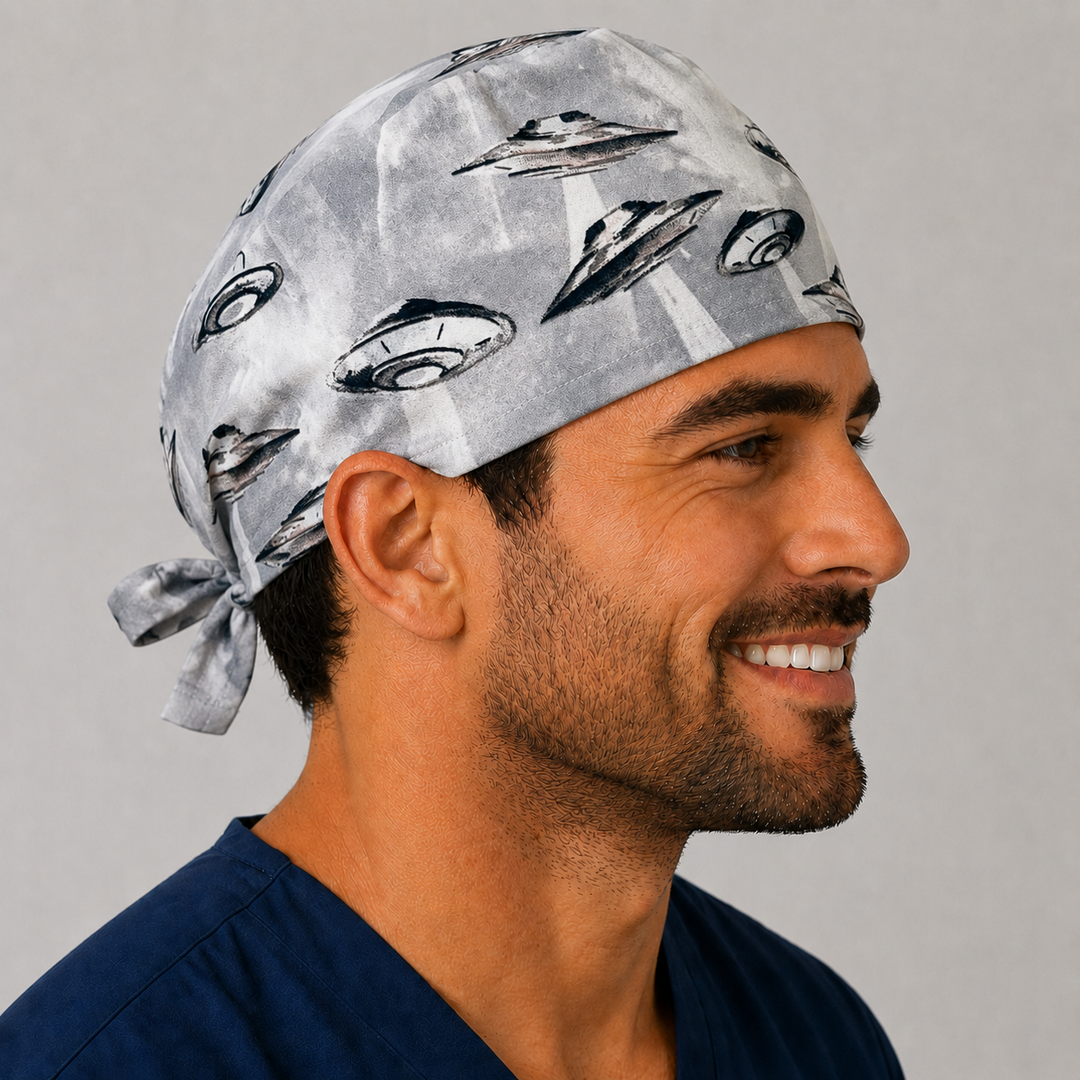 Man wearing a UFO &amp; spaceships scrub cap with flying saucers on a grey sky, front view — handmade-in-USA men&