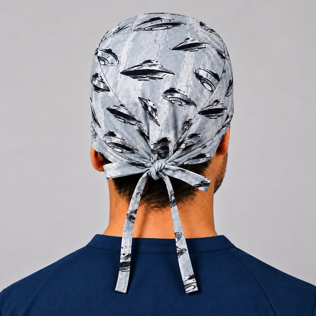 Back view of UFO spaceships tie-back scrub cap showing the bow tie closure on a male model