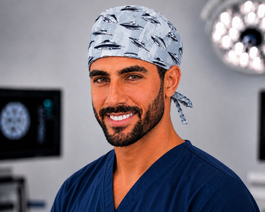 Man smiling in UFO and spaceships print scrub cap, front view in a surgical setting