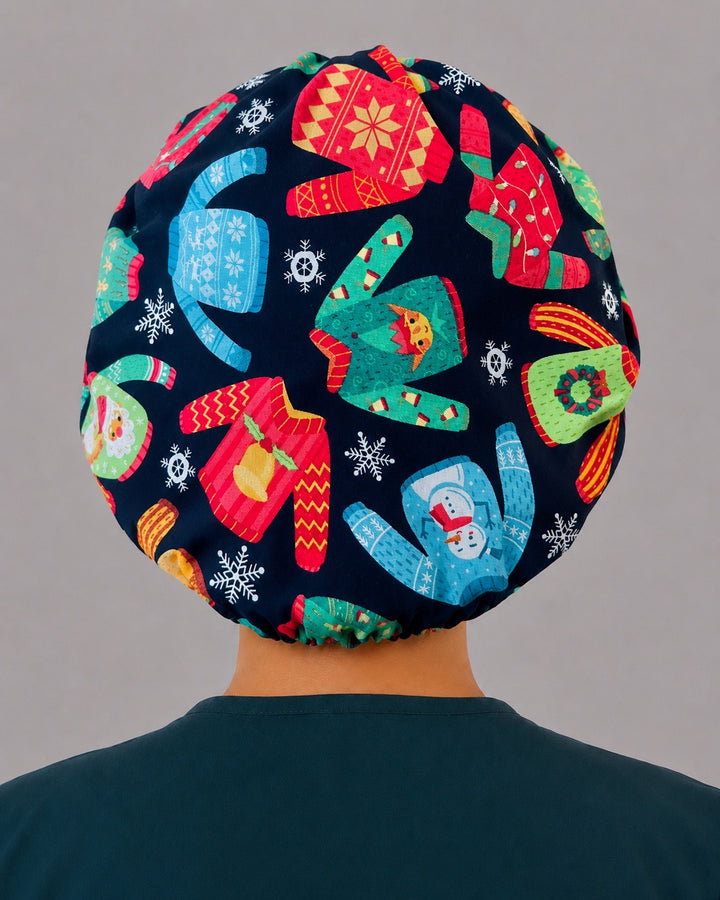 Back view of the Christmas ugly sweater bouffant scrub cap — full gathered fit showing Santa, snowman and reindeer sweaters across the navy crown