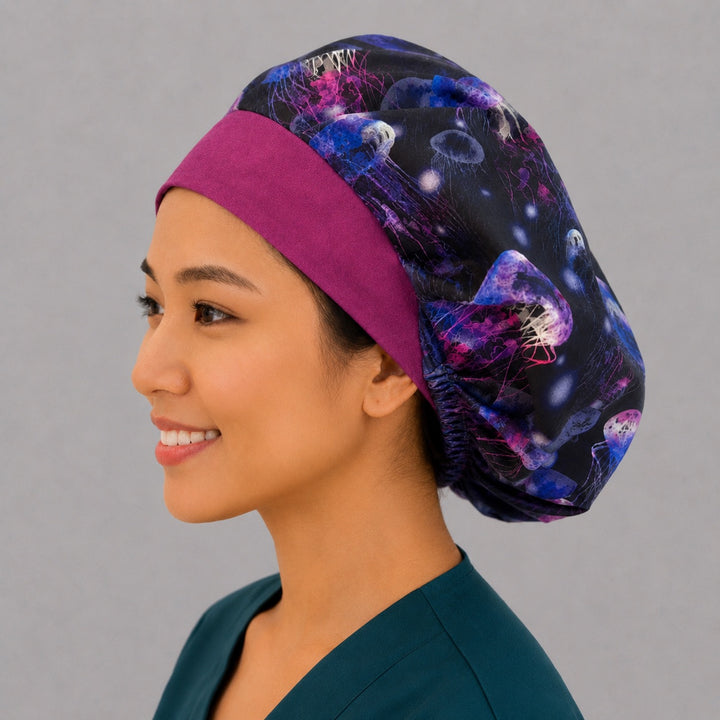 Angled view of the underwater jellyfish bouffant cap for women on a smiling nurse — handmade neon ocean surgical cap, USA made