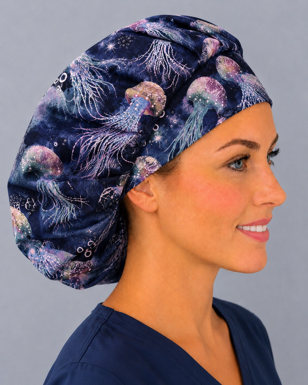 Right side profile of the underwater jellyfish bouffant surgical hat — navy batik ocean print, roomy breathable cotton cap for nurses
