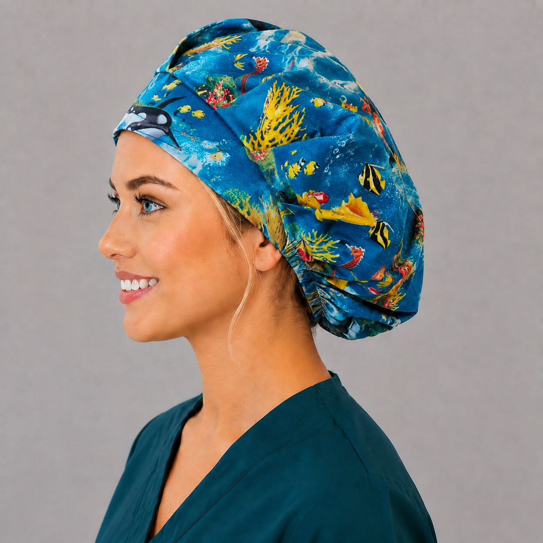 Underwater orca and dolphin bouffant cap for women, left side profile — handmade ocean life surgical cap, USA made