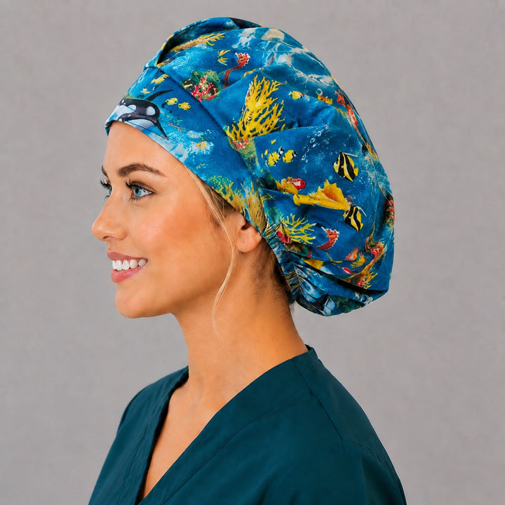 Underwater orca and dolphin bouffant cap for women, left side profile — handmade ocean life surgical cap, USA made