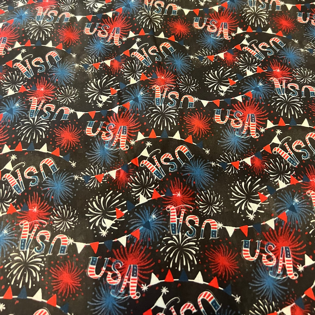 Close up of USA firework and bunting fabric on black cotton, print detail of the patriotic tie back scrub cap