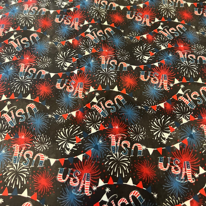 Close up of USA firework and bunting fabric on black cotton, print detail of the patriotic tie back scrub cap