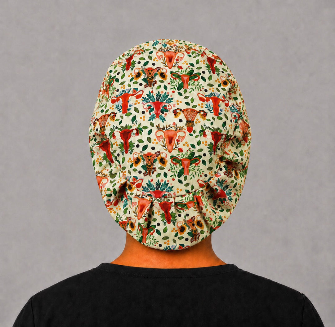 Back view of the uterus floral Euro scrub cap — full coverage showing the anatomical uterus and greenery print across the crown
