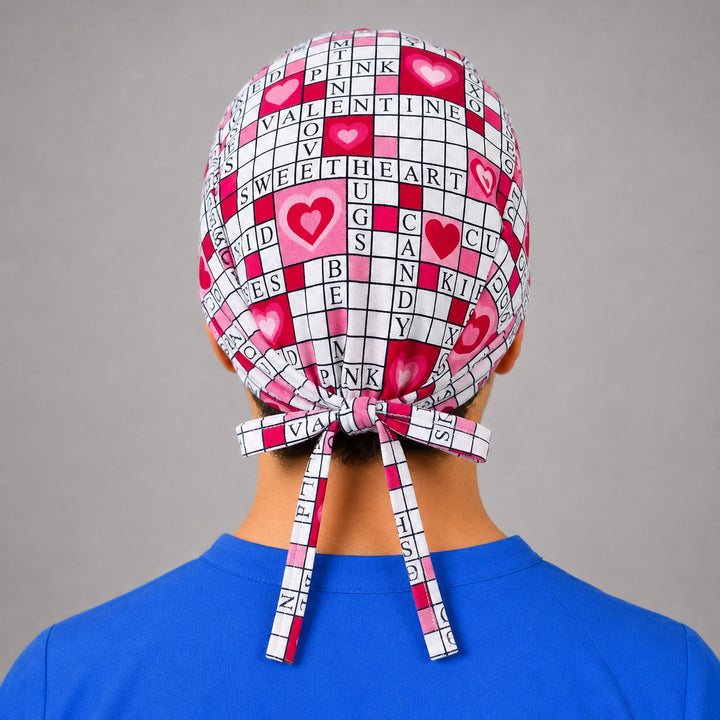 Back view of adjustable tie-back knot on pink Valentine crossword unisex surgical hat