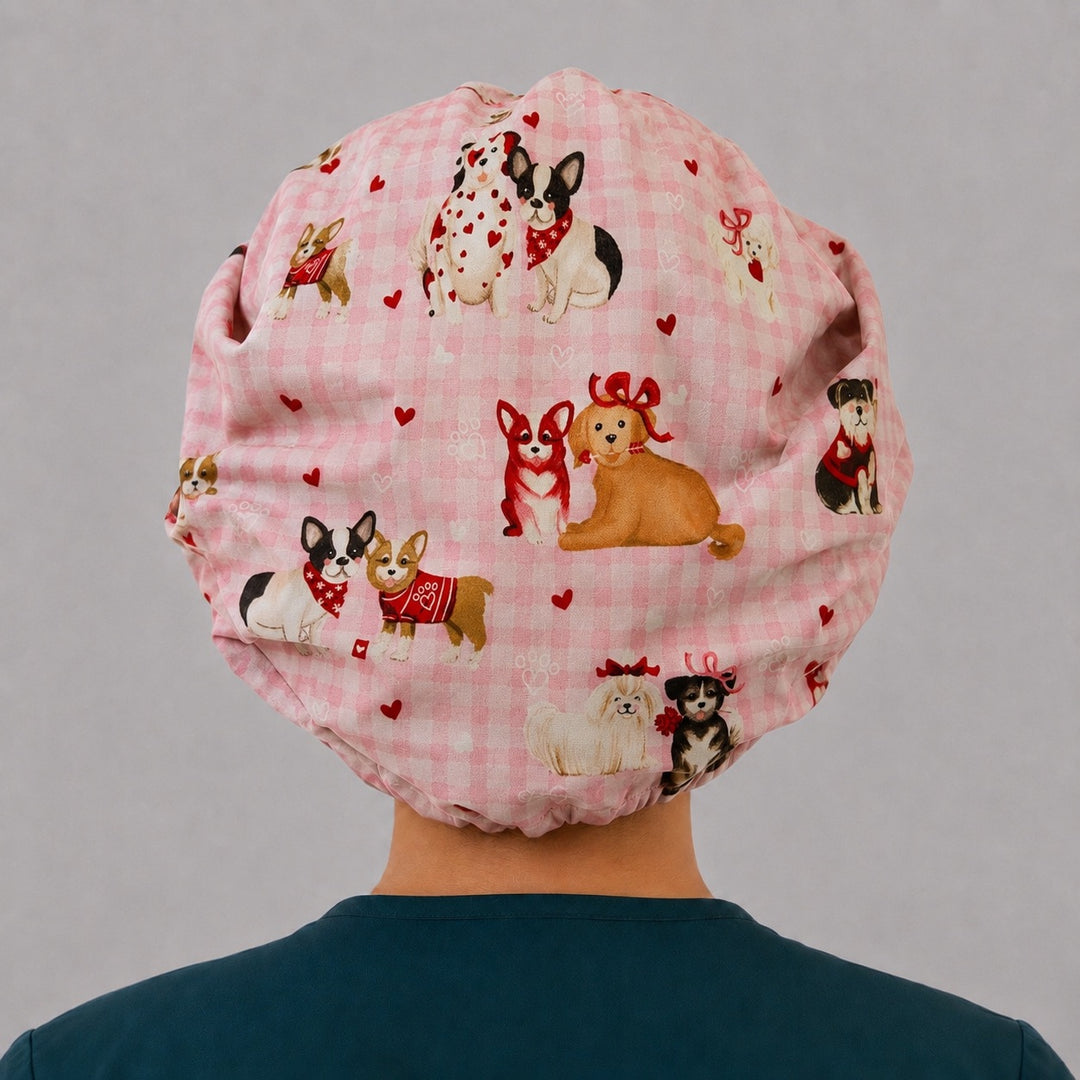 Back view of the Valentine dog bouffant scrub cap — full gathered fit showing puppies in bandanas and red hearts on pink gingham