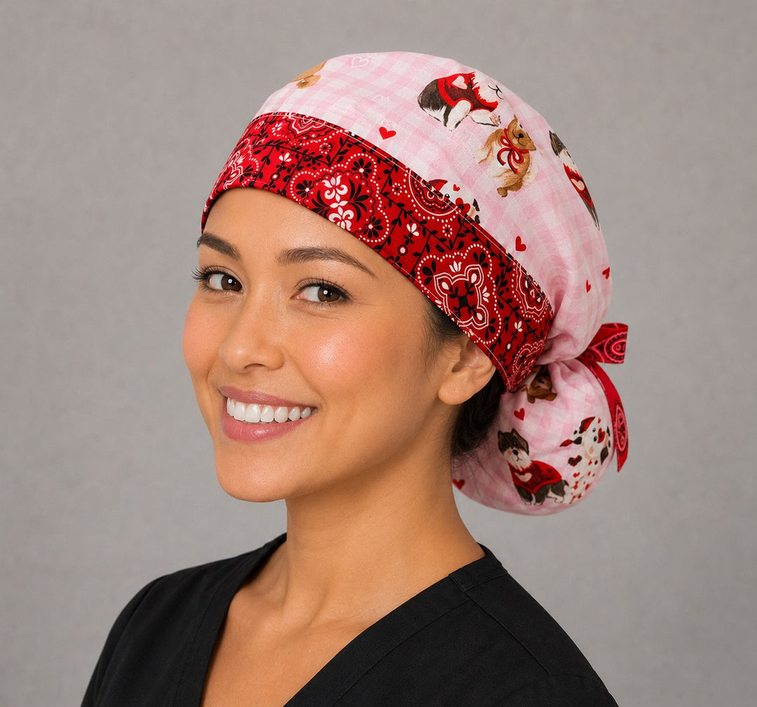 Valentine dogs ponytail scrub cap right side profile with full ponytail pouch of puppies, hearts and bows on pink gingham and long red bandana ribbon ties