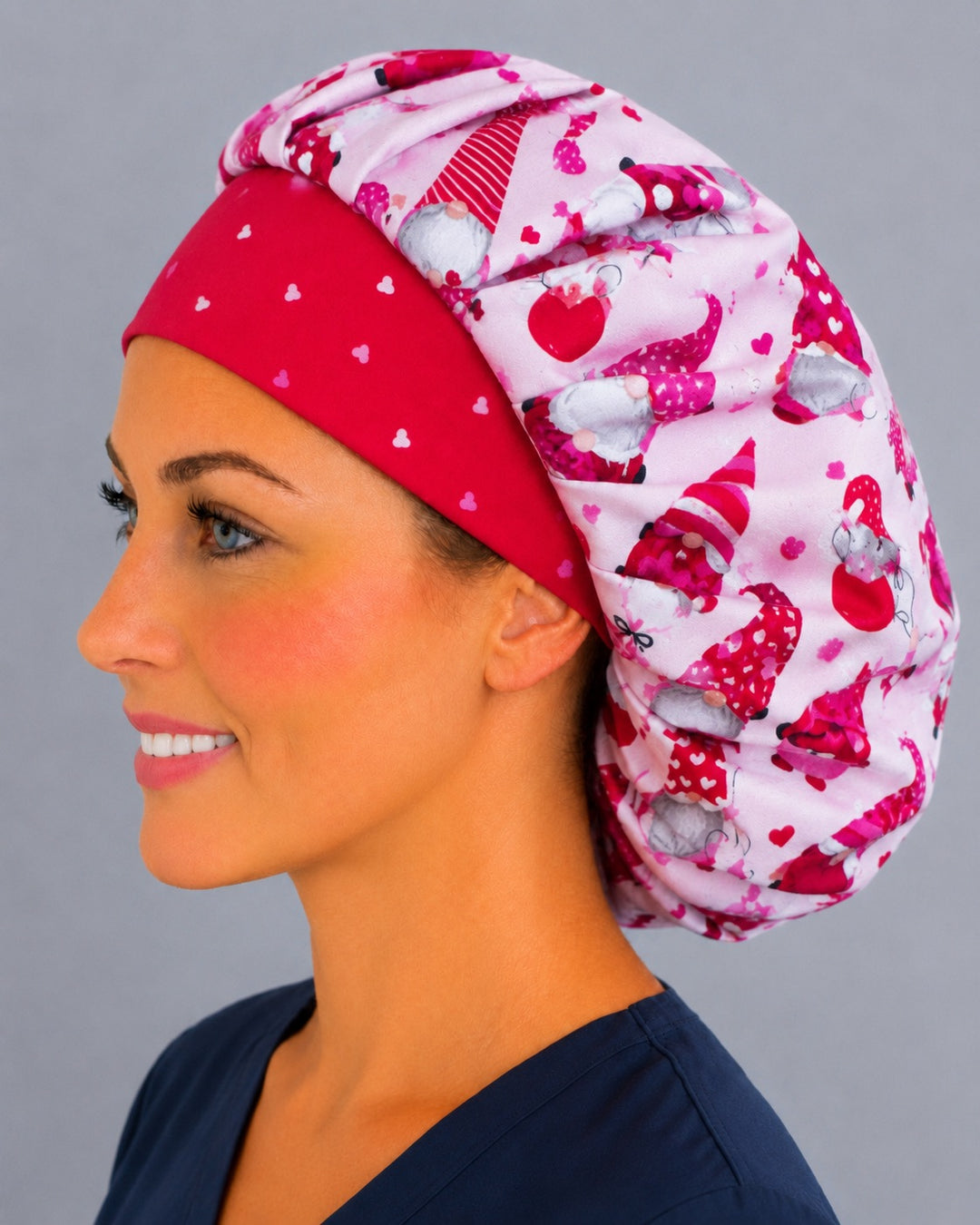 Back view of the Valentine gnomes bouffant scrub cap — full roomy fit showing gnomes with LOVE and XO banners, hearts and balloons on pink