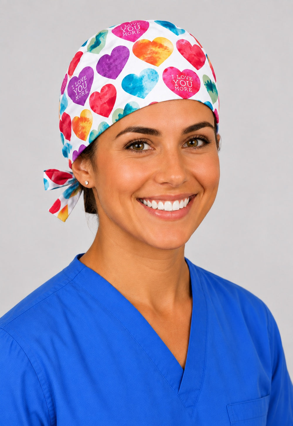 Valentine heart tie back surgical cap in left angled view, smiling nurse in watercolor I Love You More print