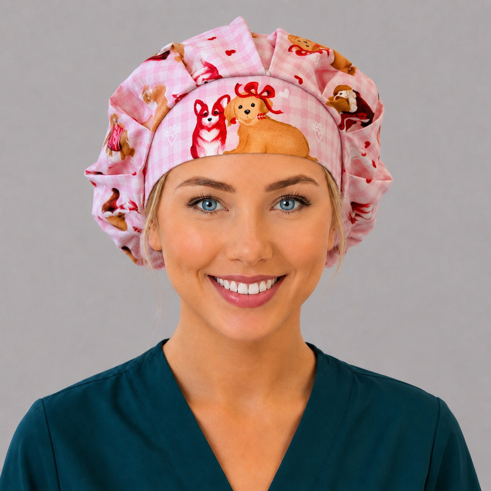 Woman wearing a Valentine puppy bouffant scrub cap, front view — watercolor dogs and red hearts on pink gingham, adjustable women's surgical hat