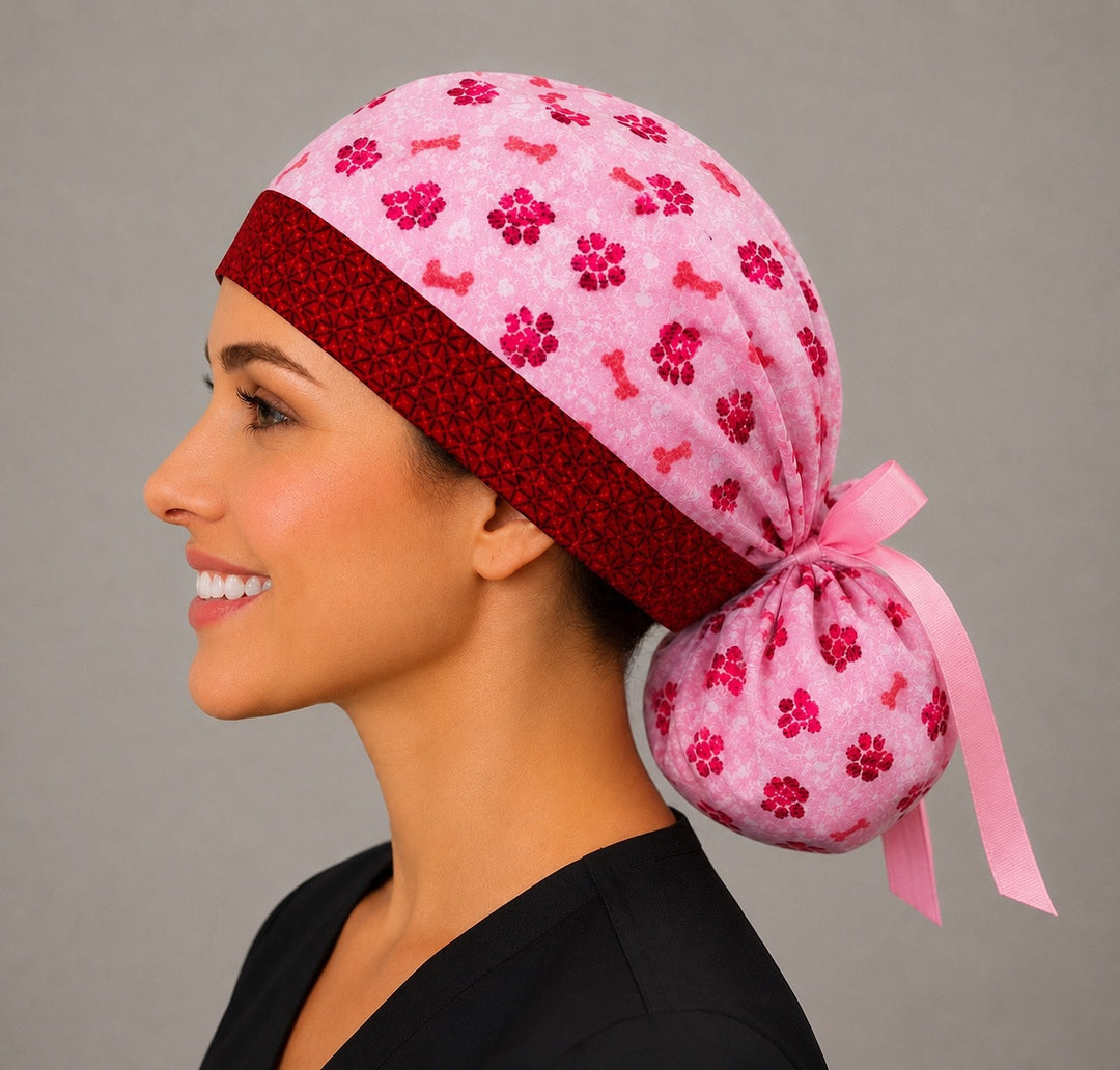 Valentine puppy paws and bones ponytail scrub cap right side profile showing gathered pouch of pink and red paw prints and dog bones with pink ribbon tie