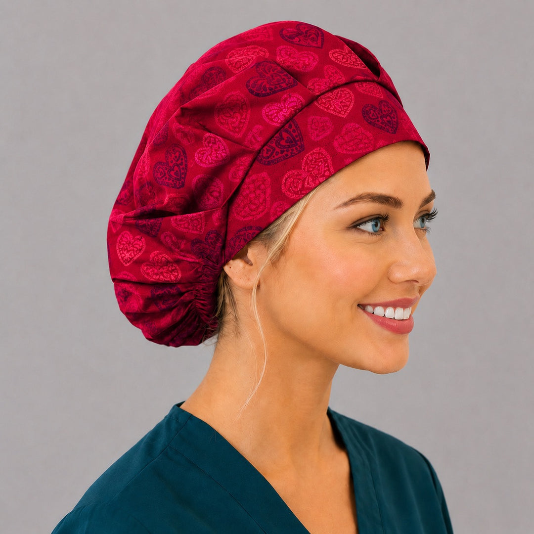 Right side profile of the Valentine red heart bouffant surgical hat — crimson and plum lace hearts, roomy breathable cotton cap for nurses