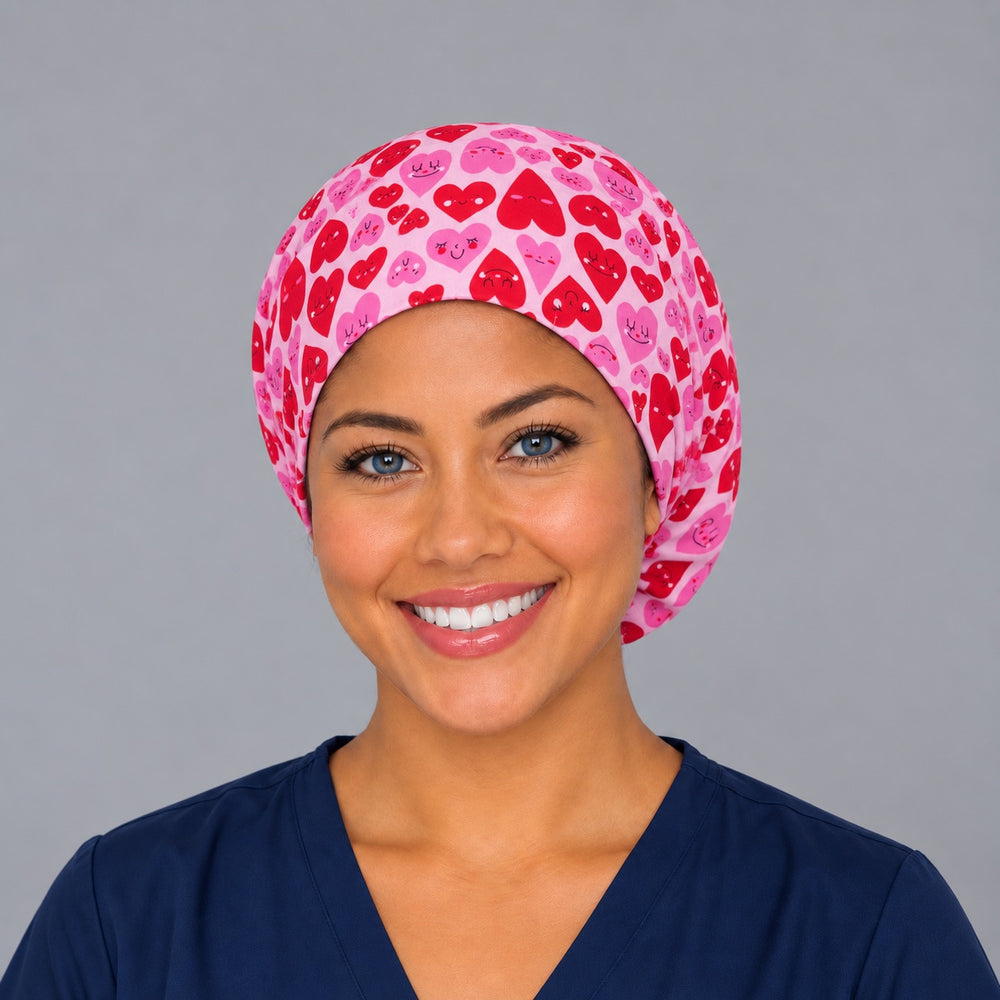 Woman wearing a Valentine Vibes Euro scrub cap, front view — smiling red and pink hearts on pink, adjustable Valentine's surgical hat