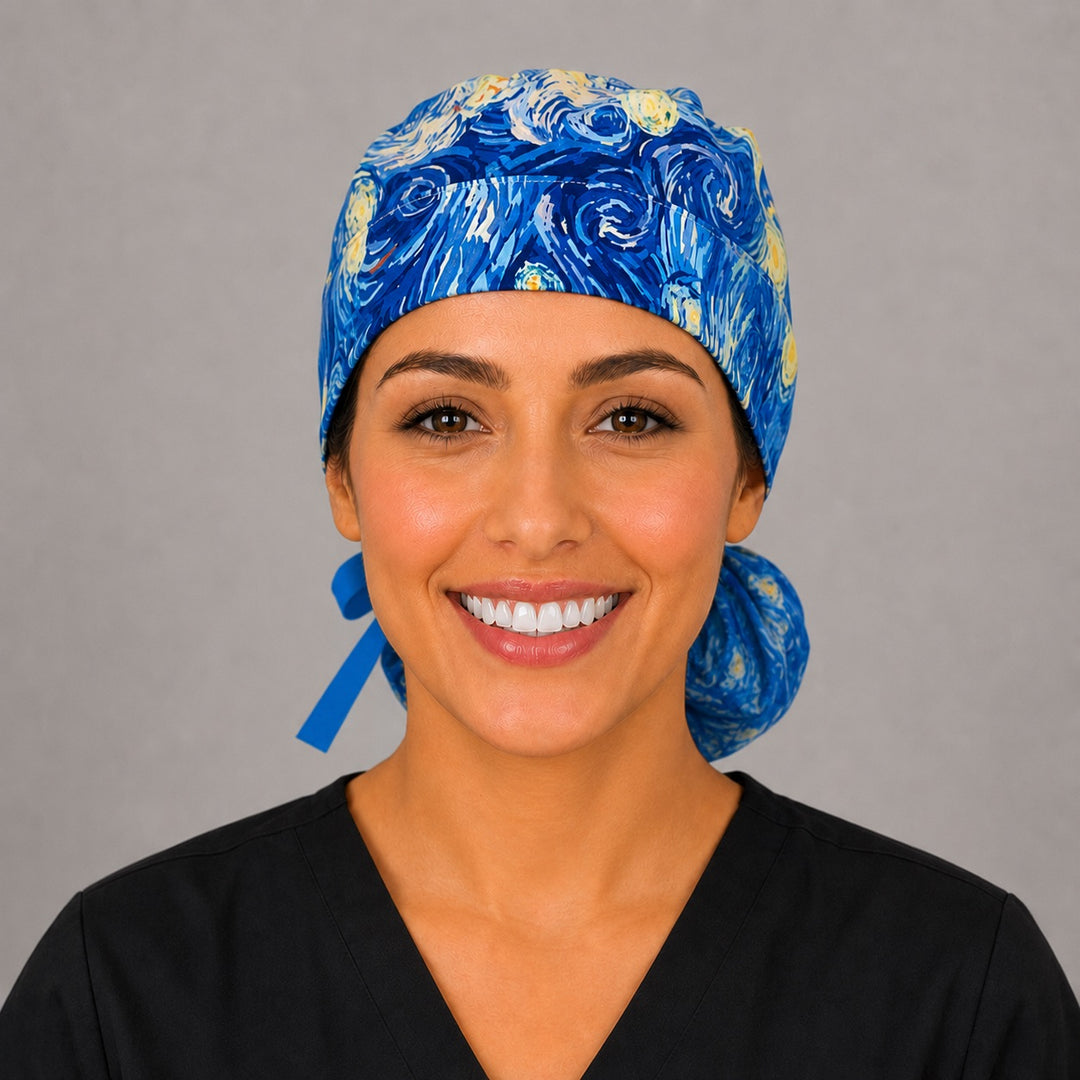 Woman wearing Van Gogh Starry Night ponytail scrub cap, front view smiling with swirling blue, turquoise and gold impressionist print and blue ribbon tie