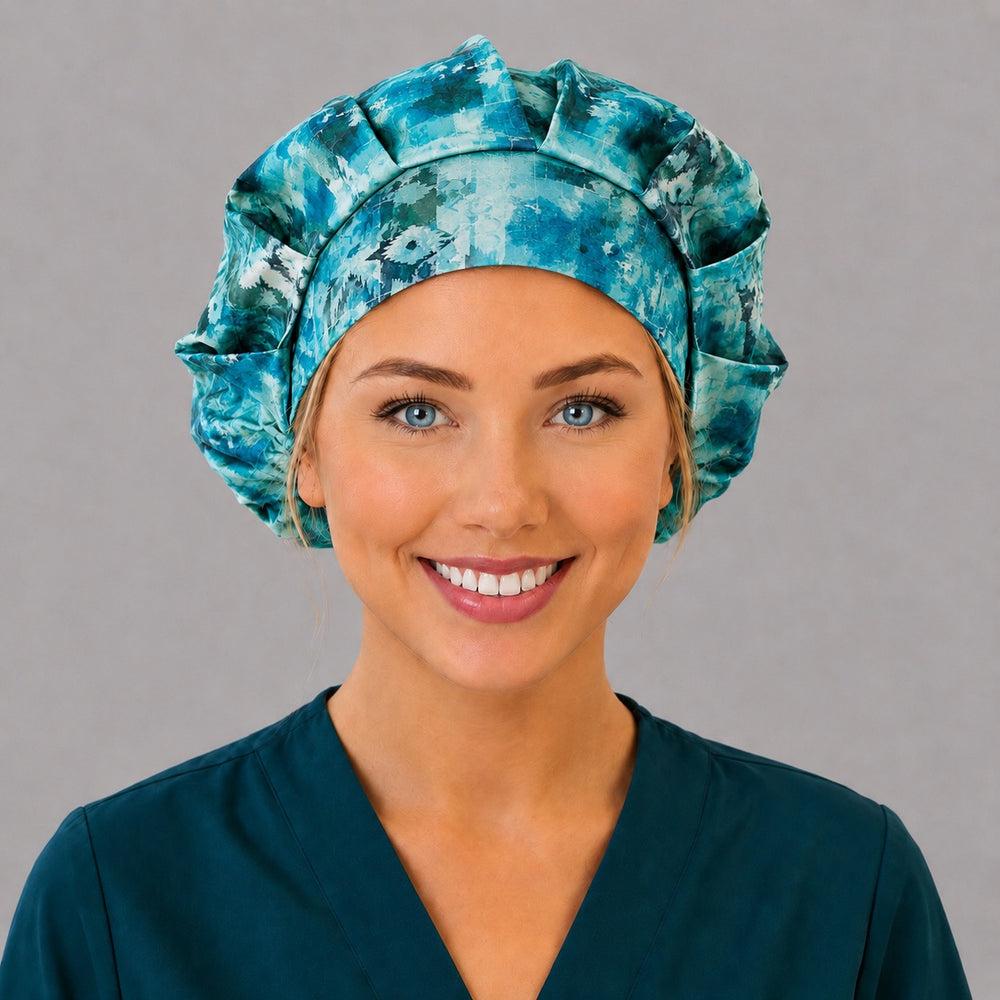 Woman wearing a vintage icicles bouffant scrub cap, front view — geometric aqua, teal and white batik icicle print, adjustable women's surgical hat