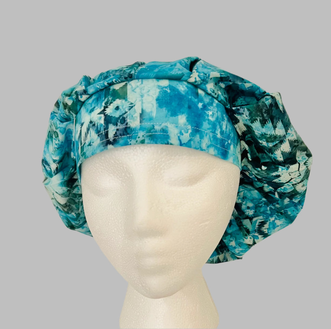 Side view of aqua &amp; teal vintage icicle bouffant scrub cap — handmade USA winter surgical hat for OR nurses with room for long hair.