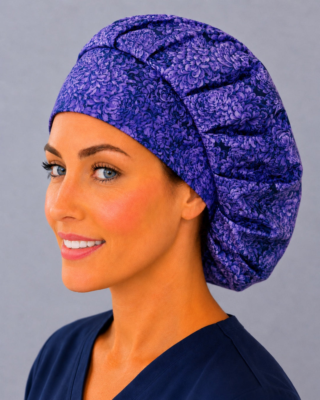 Violet bloom bouffant surgical cap for long hair, left angled view — deep gathered fit that secures thick or braided hair