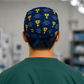 Back view of navy "Voted #1 Surgeon" trophy tie-back scrub cap with bow tie closure — handmade-in-USA OR World surgical hat, gift for surgeons.