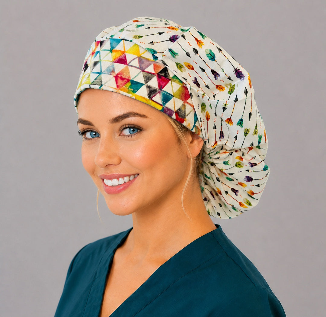 Watercolor arrow bouffant scrub cap, left angled smiling view — purple, aqua and orange feather print for OR nurses and surgical techs