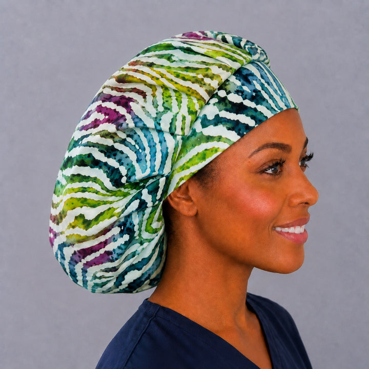 Right side profile of the watercolor zebra stripe bouffant surgical hat — batik animal print, roomy breathable cotton cap for nurses