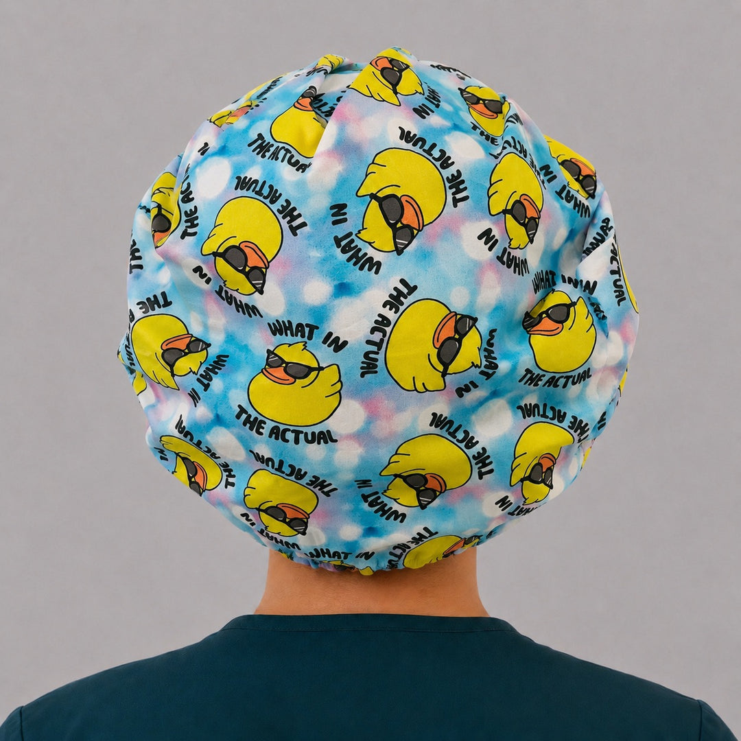 Back view of the What in the Actual Duck bouffant scrub cap — full gathered fit showing sunglasses ducks and lettering across the crown