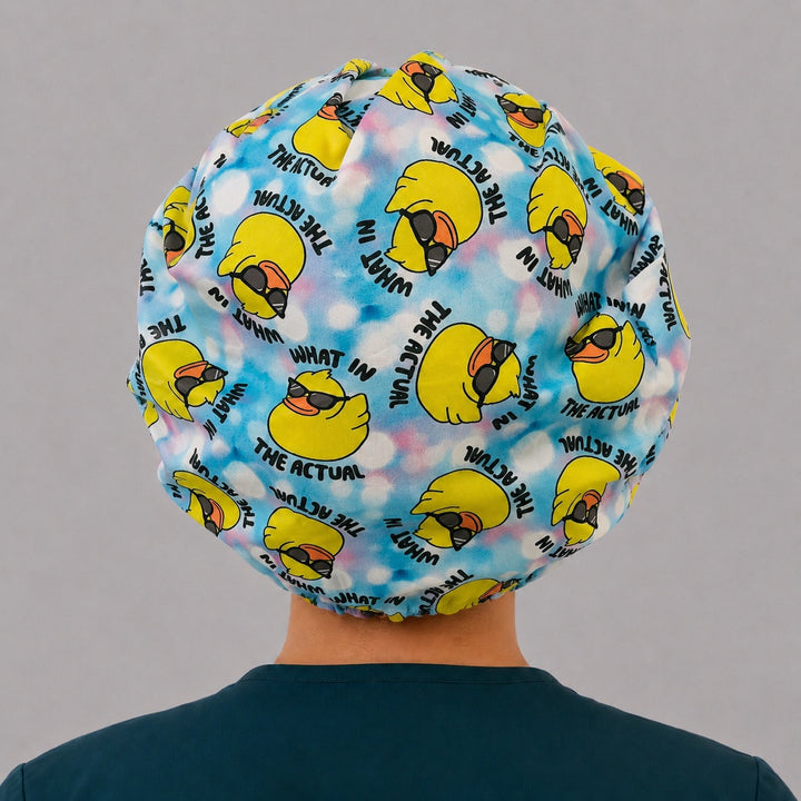 Back view of the What in the Actual Duck bouffant scrub cap — full gathered fit showing sunglasses ducks and lettering across the crown