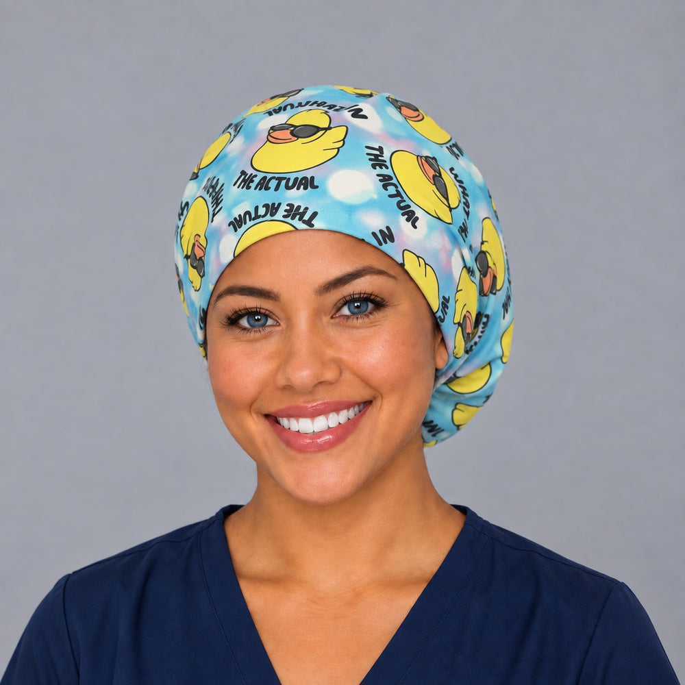 Woman wearing a What in the Actual Duck Euro scrub cap, front view — sunglasses ducks on tie-dye, adjustable funny surgical hat