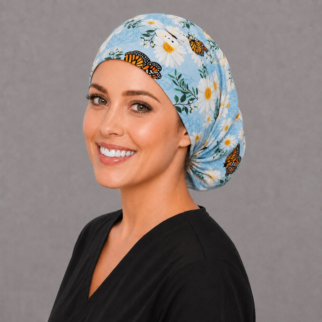 White daisy and blue Euro surgical cap, left angled view — elastic adjustable back with full head coverage