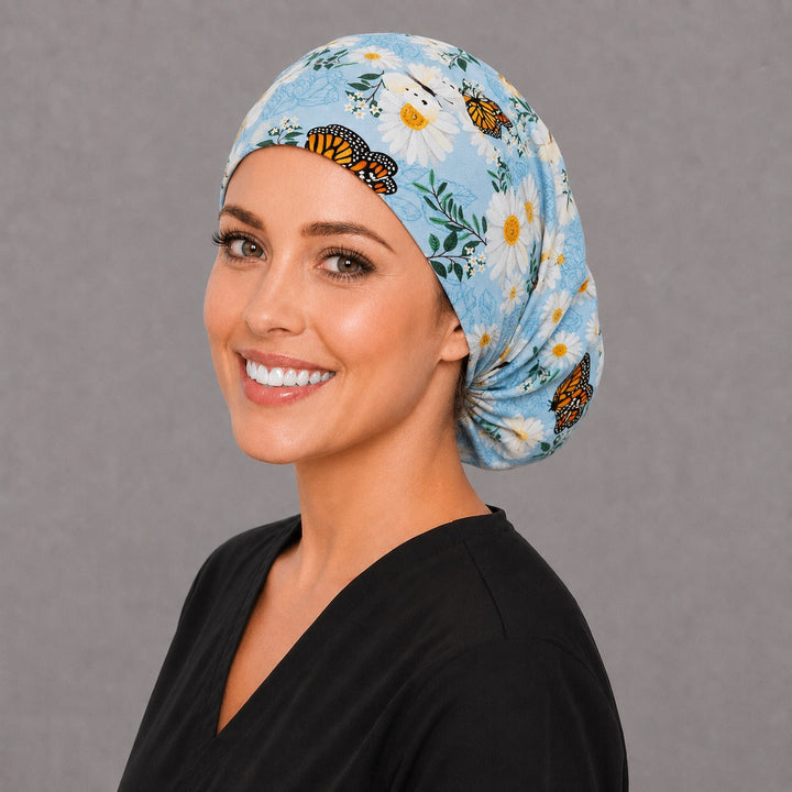 White daisy and blue Euro surgical cap, left angled view — elastic adjustable back with full head coverage