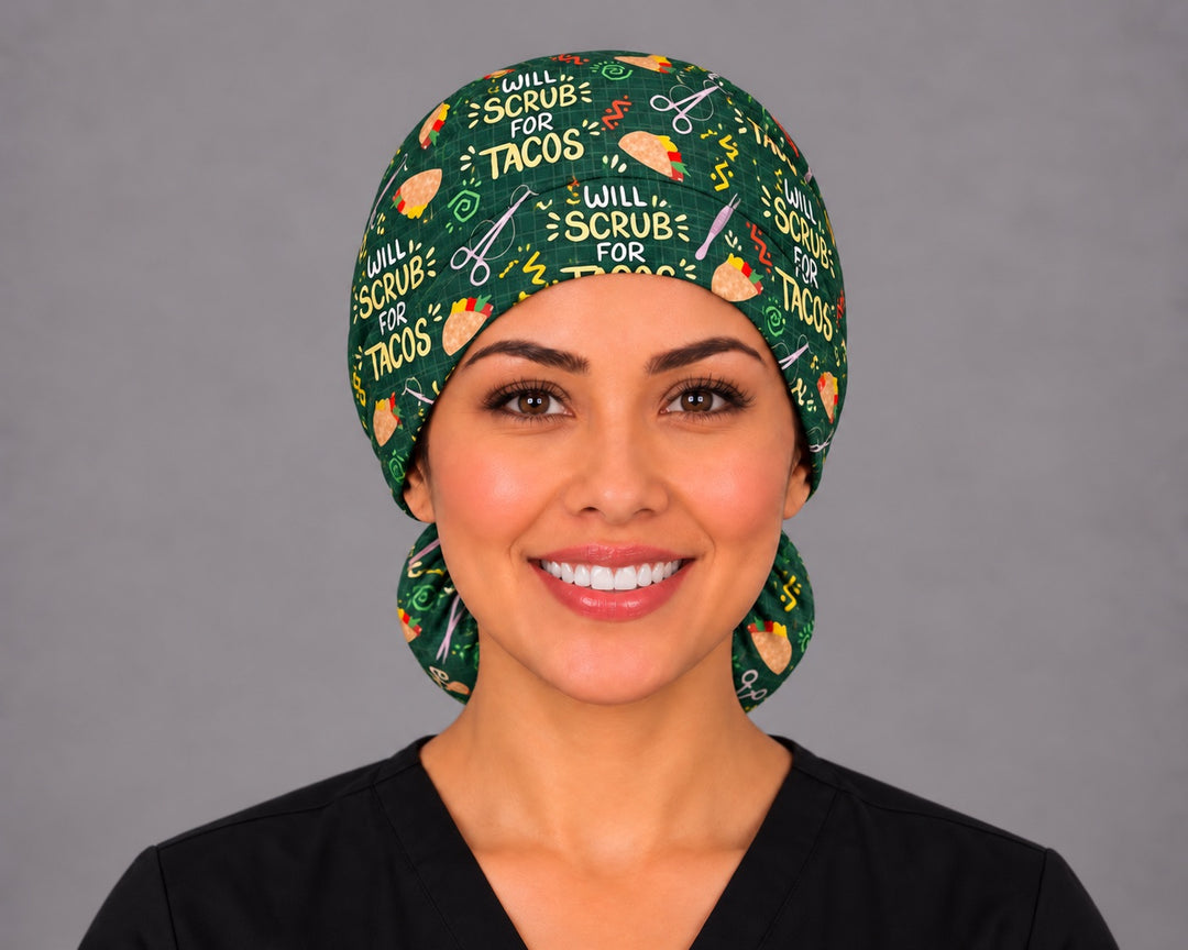 Smiling nurse in black scrubs wearing a Will Scrub for Tacos ponytail scrub cap, front view with the yellow slogan across the forest green crown