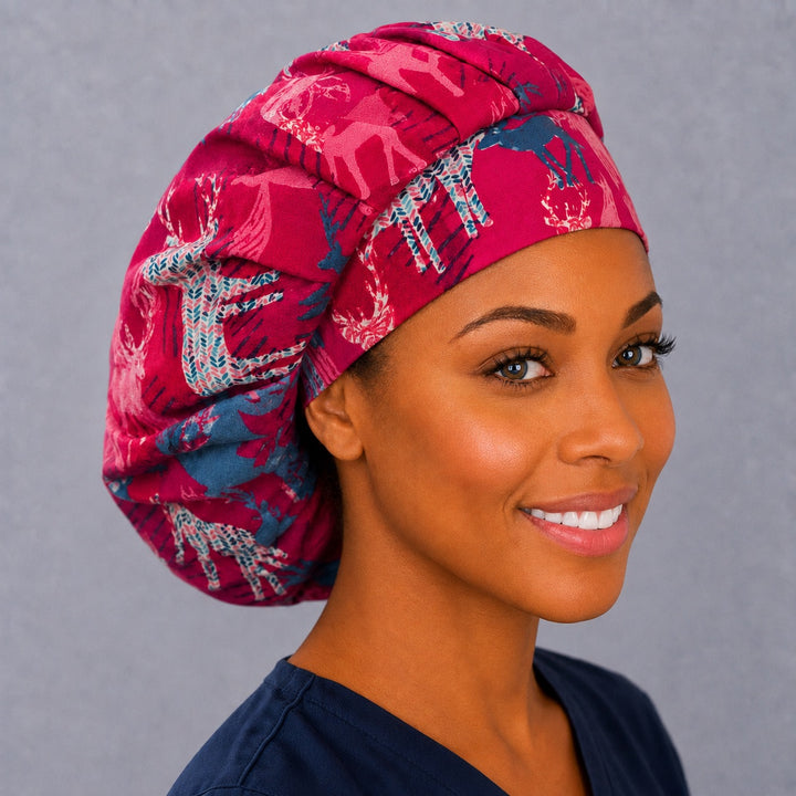 Winter deer bouffant scrub cap, left angled smiling view — knit-patterned stags on pink for OR nurses and surgical techs